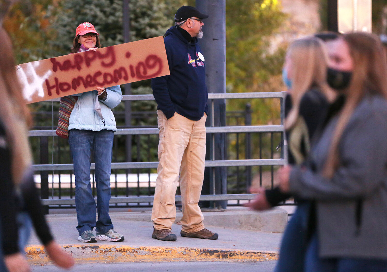 Marjorie Mantle peaks over her #happyhomecoming sign on the bridge
